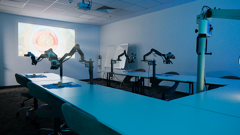 Wet-lab training room with multiple surgical workstations and retinal projection
